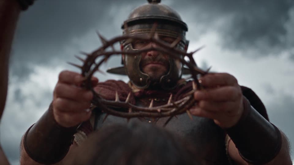Looking up at a Roman soldier holding the crown of thorns