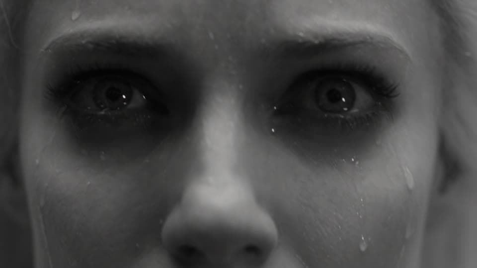 Extreme close-up of the white angel’s eyes, wet with rain
