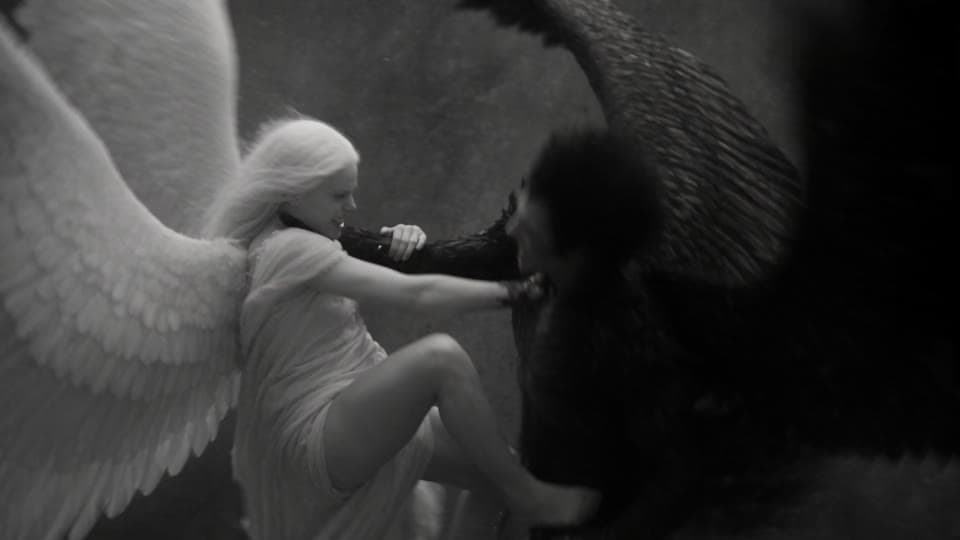 Shot 10: Her foot on his back, she pulls his wing.