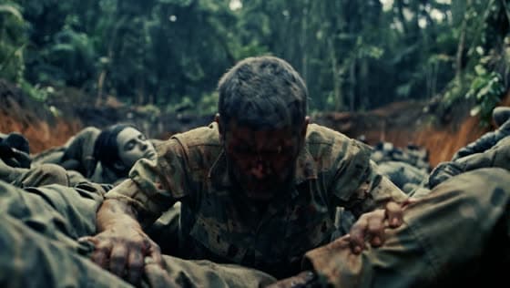 Wide shot: the soldier crawling through a trench