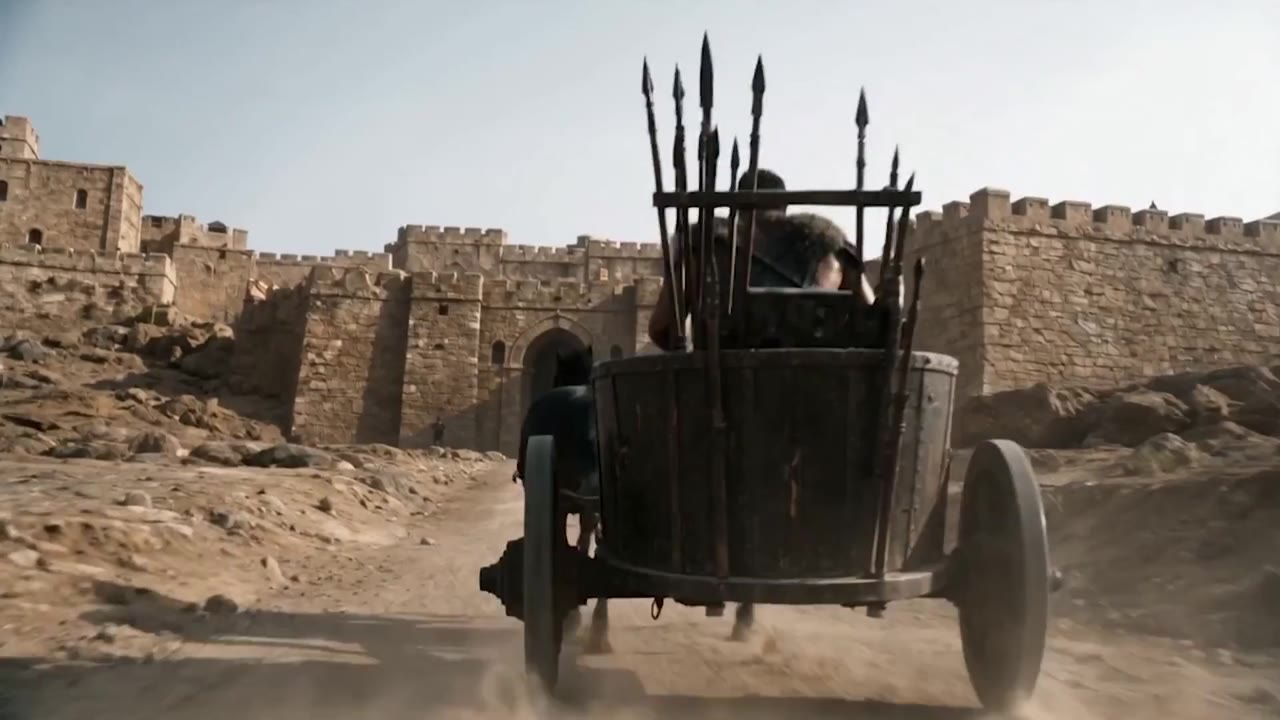 Jehu's chariot racing beneath the city walls in a wall of dust
